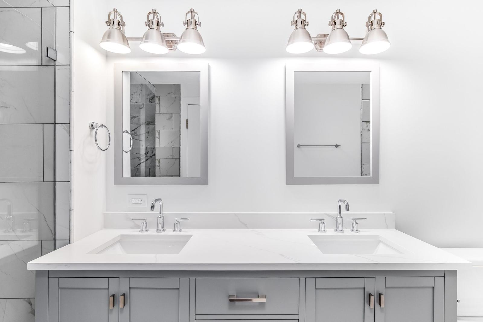 Classic renovation detail focusing on intricate crown molding work and restored hardwood floors in a herringbone pattern.