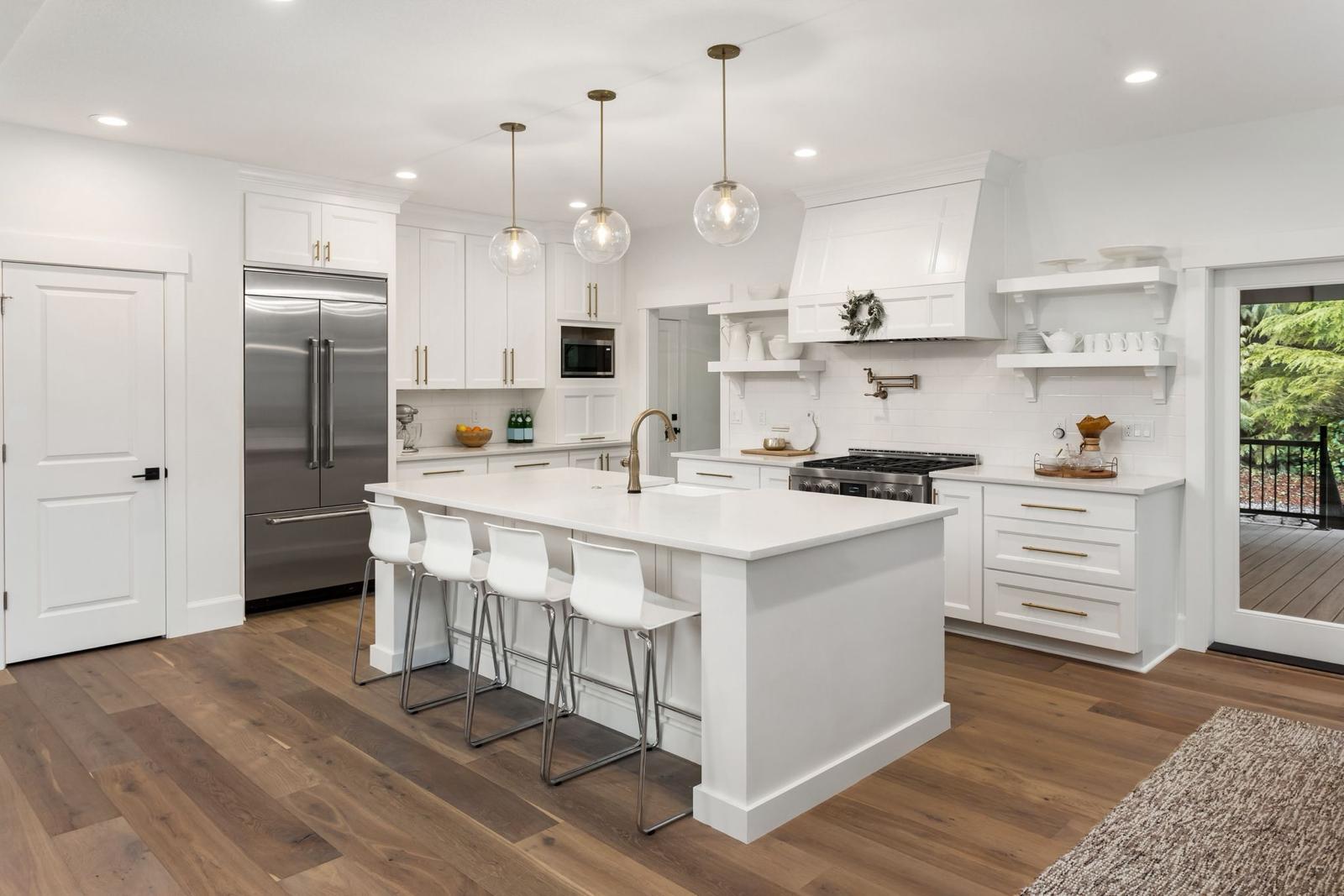 Open concept living space transitioning seamlessly from a gourmet kitchen to a sun-drenched living room with panoramic windows.